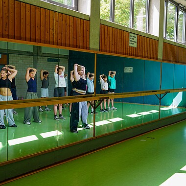Symbolbild Teilnehmer dehnen sich während der IG im Camp Breisach 2026